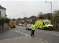 Police and ambulance crews help man collapsed in street