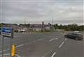 Car on roof blocks road 