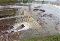 Water cascades from Thames after Storm Ciara