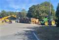 A-road blocked as tractor spills straw bales on roundabout