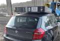 Car with stolen TV strapped to its roof pulled over by police