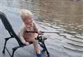 Toddler ‘goes fishing’ in flooded street