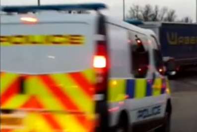 A police van approaches the junction just as the lorry makes the maneuver