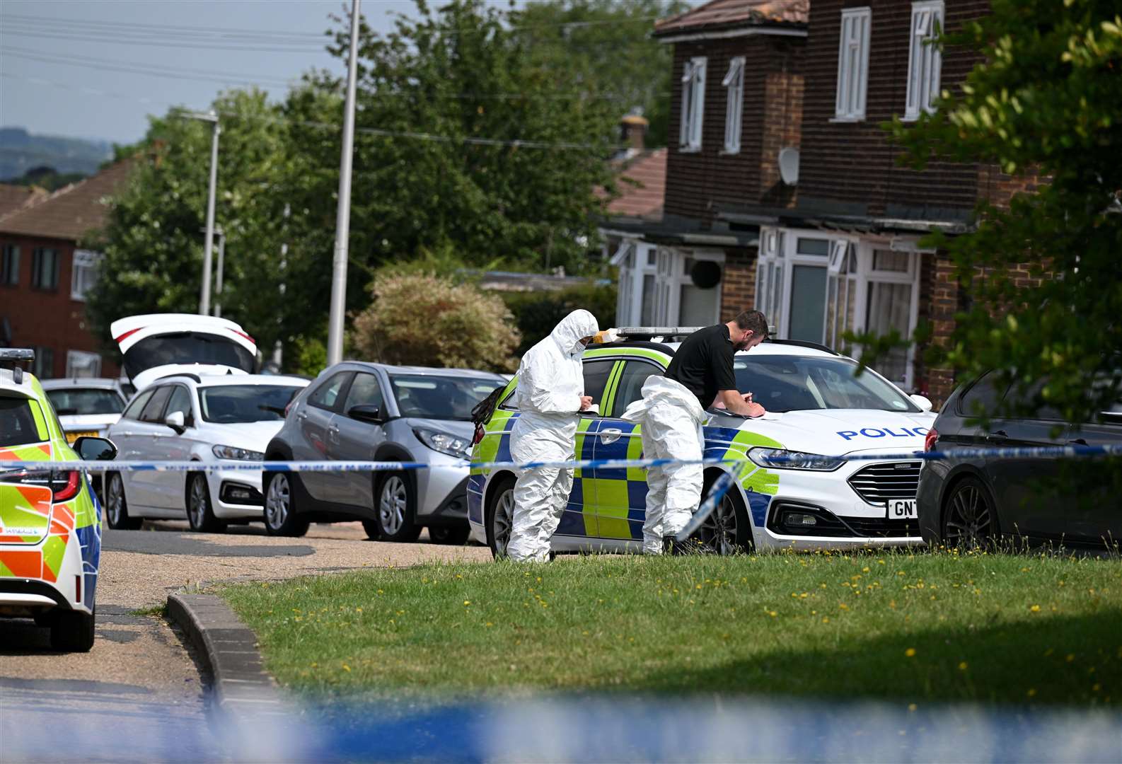 Forensics pictured in Mooring Road, Rochester, where a motorbike believed to be connected to the stabbing was found last night. Picture SWNS