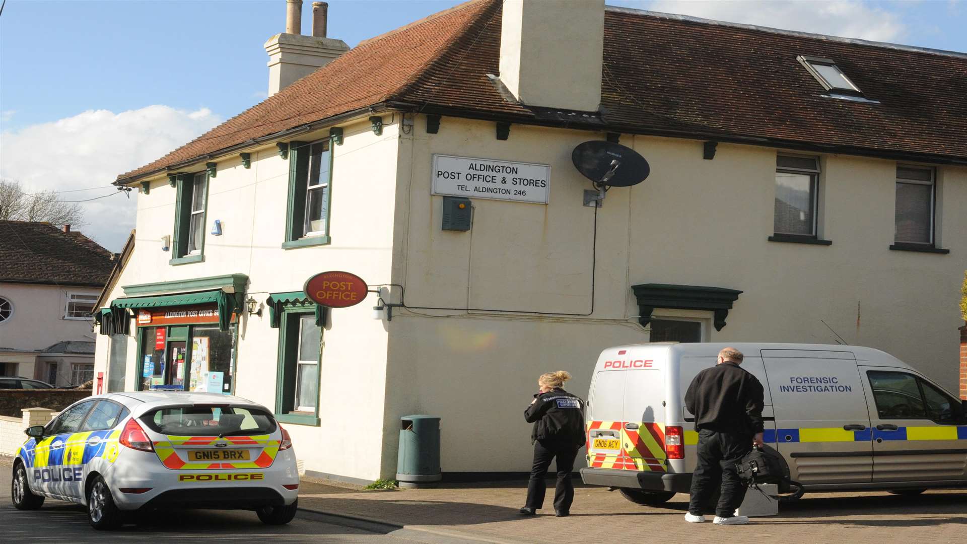 Police at the scene of the robbery at Aldington Post Office