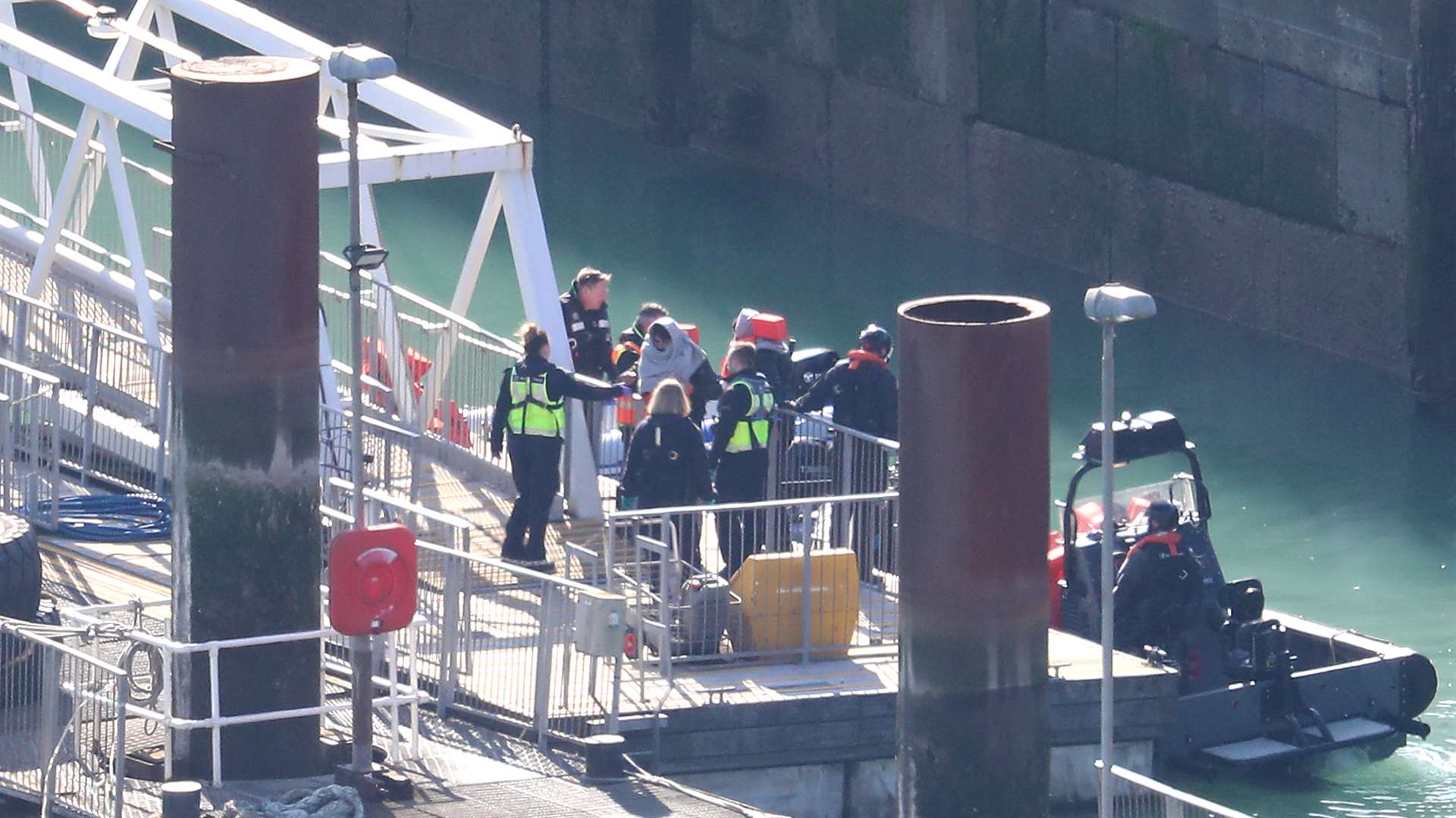 Border Force officers take men thought to be migrants to shore in Dover, Kent (Gareth Fuller/PA)