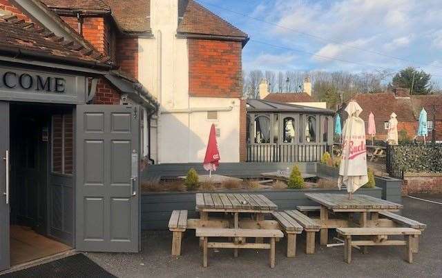 There are a number of wooden picnic tables outside the front door but no-one was using them when we arrived