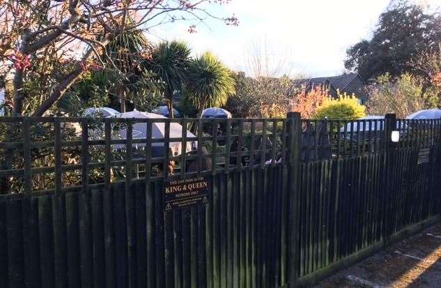 A view of the garden over the fence from the King & Queen car park – there are stacks of spaces to the front, back and side of the pub