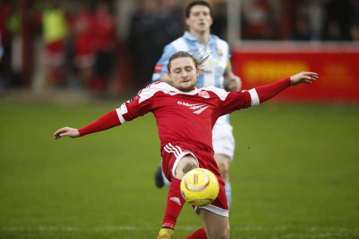 Alfie May slides in but clips the post. Picture: Martin Apps.