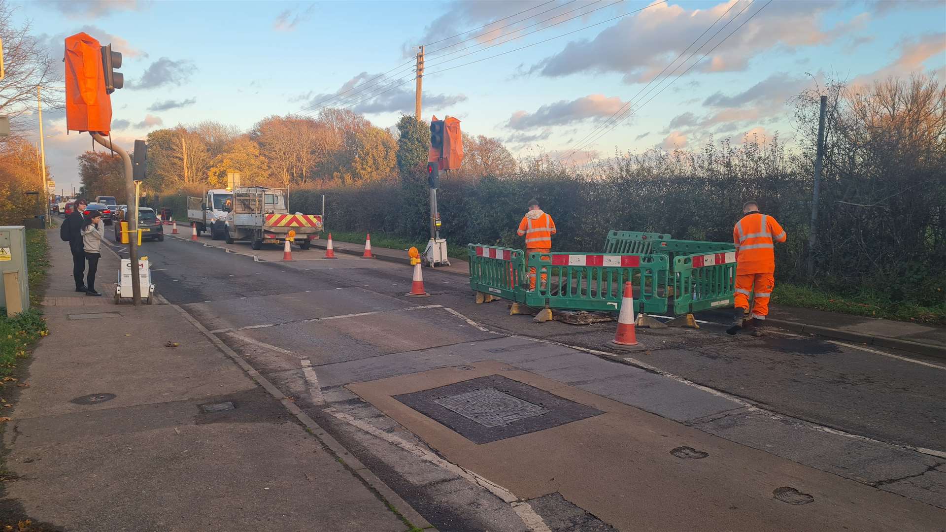 Workmen are replacing loose drain covers on the A28 at Sturry