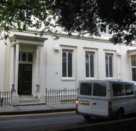 A private ambulance leaves with the body of a man found in a block of flats in Hawley Square, Margate