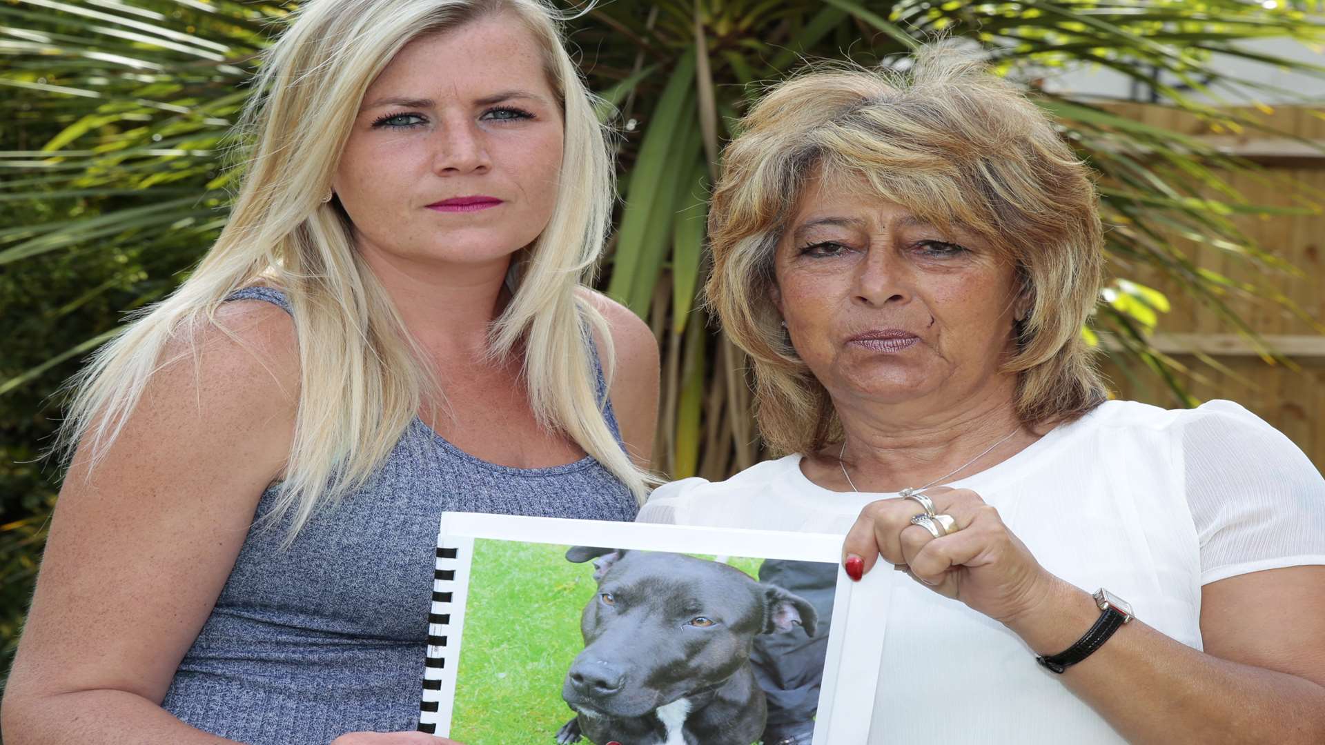 Sam Holden and Christine Hoadley hold a photo of Bud