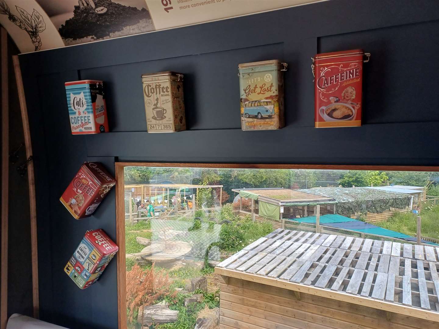 Coffee and tea tins have been put up along the walls of the carriage