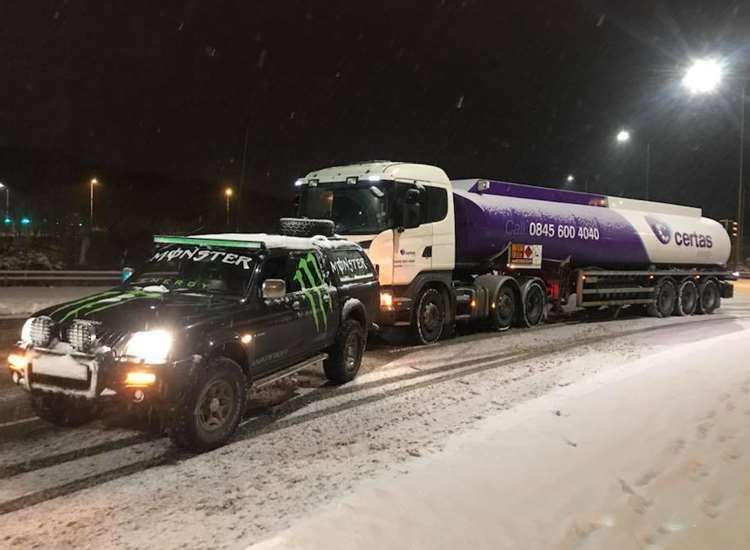 Andy Williams pulling a truck during the storm (30314160)