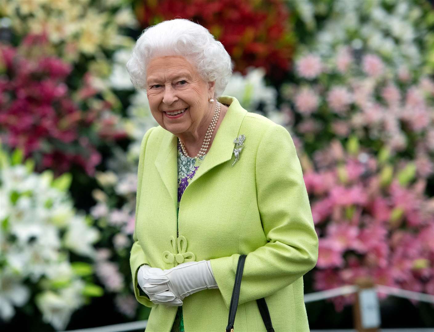 They wished the monarch a happy birthday alongside a picture of William and Kate showing the Queen around the duchess’s garden at the Chelsea Flower Show last year (Geoff Pugh/PA)