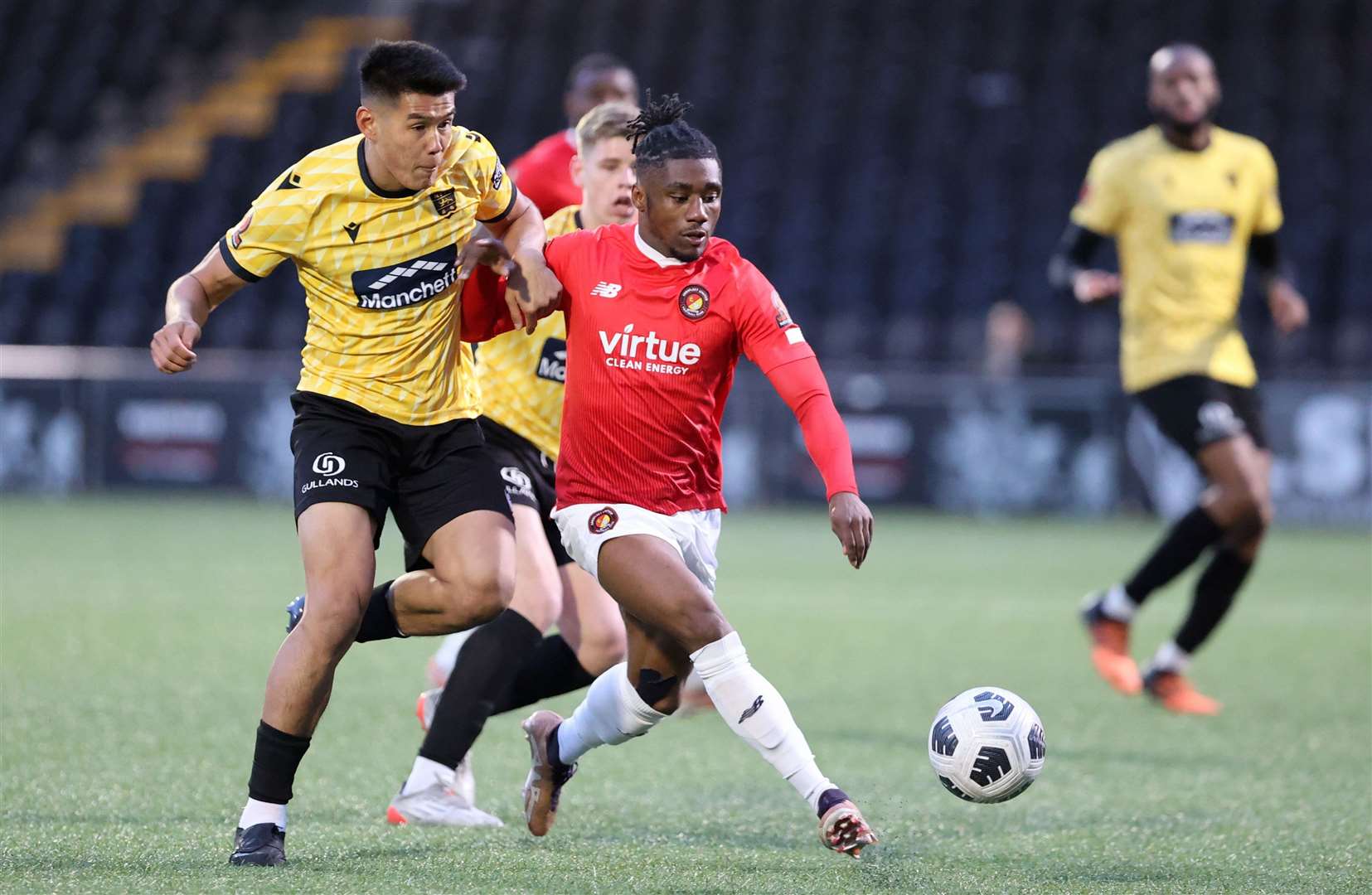 Ebbsfleet forward Darren McQueen tries to break clear of Bivesh Gurung. Picture: PSP Images