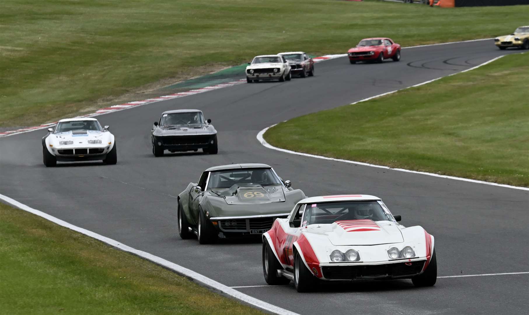 Nik Baatz, leading, and Tim Davis (69) won a race each in the Ford vs Chevy races in their 1969 Chevrolet Corvettes. Picture: Simon Hildrew