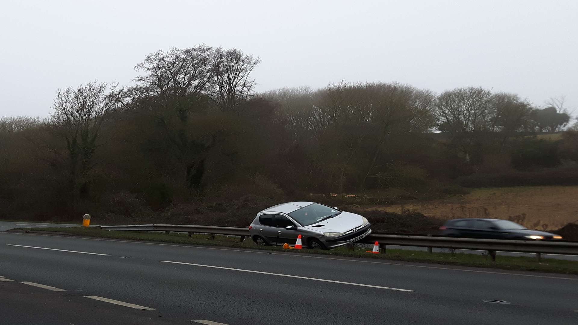 The Peugeot facing the wrong way down the A249 near the turn-off for Hucking