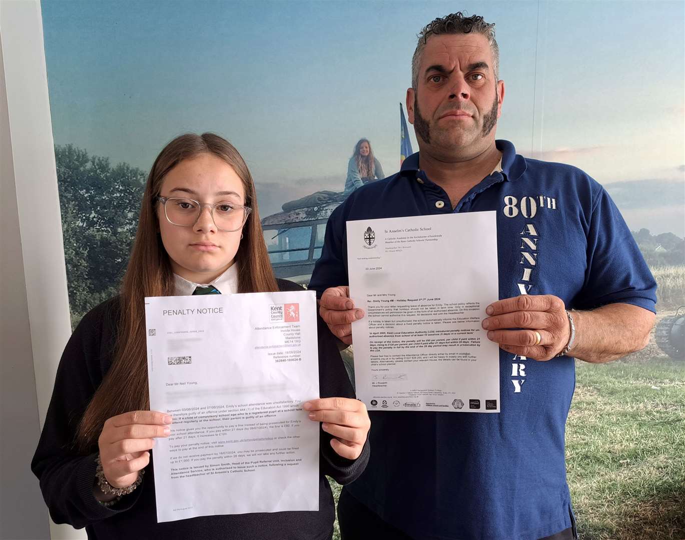 Emily Young, 14, holds up one of the fines issued to her parents, Neil and Annette Young