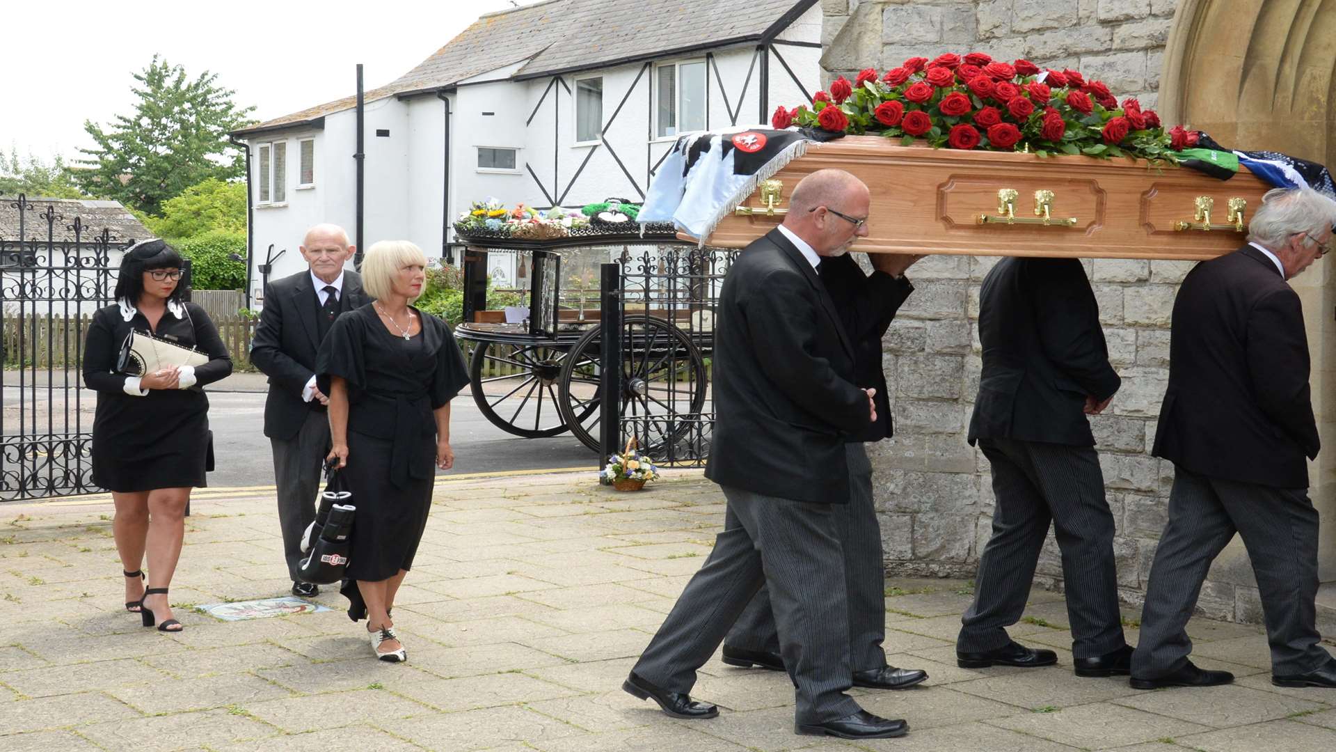 Jordan Lupton is carried into church followed by his family