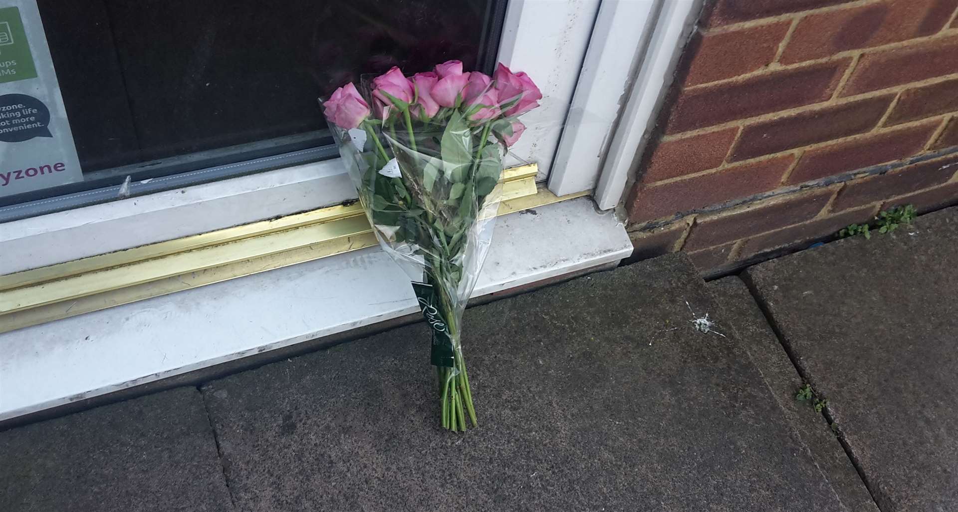 The floral tribute outside Deola Food Store in North Street, Milton