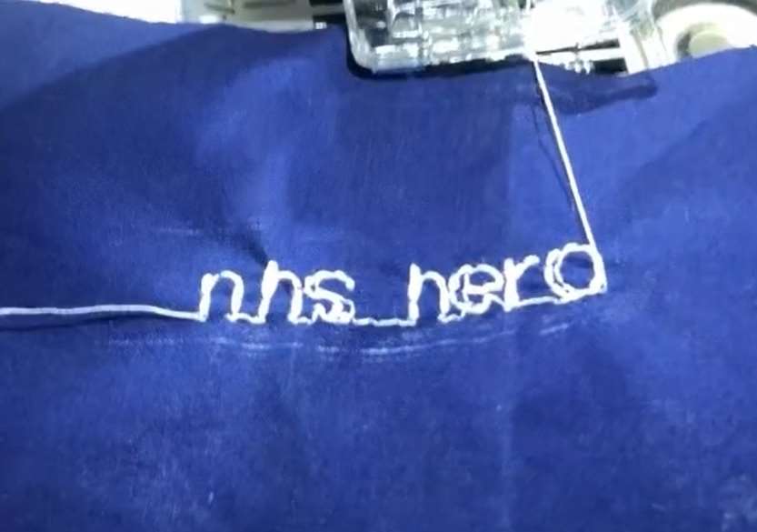 Elaine van der Schoot is embroidering the words ‘NHS hero’ into her scrubs (PA)