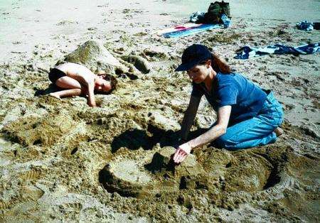 Joshua and Colleen play in the sand on a trip to the beach.