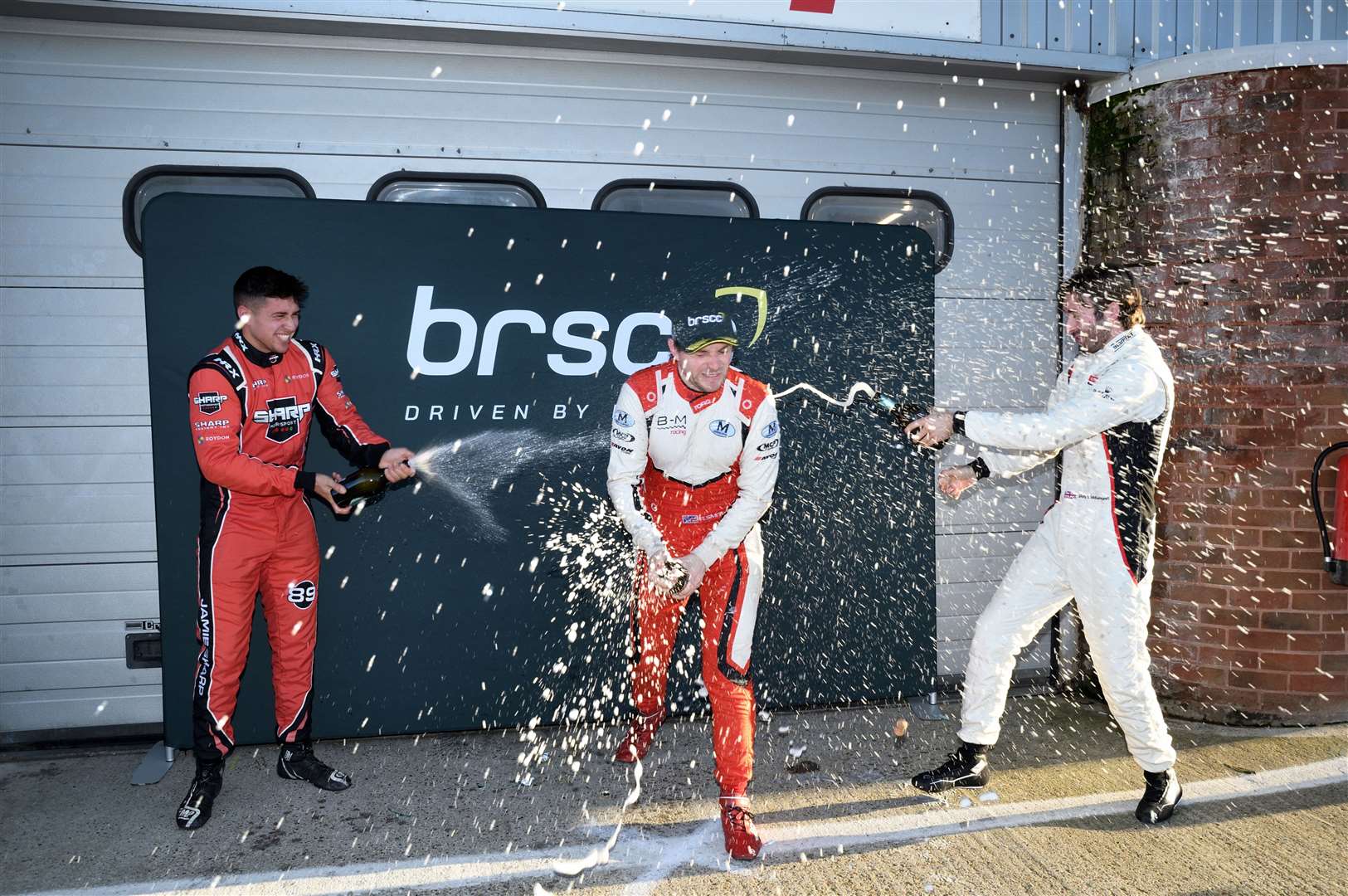 Smith, centre, celebrates winning the final with Jamie Sharp, left, and Chris Middlehurst. Picture: Simon Hildrew