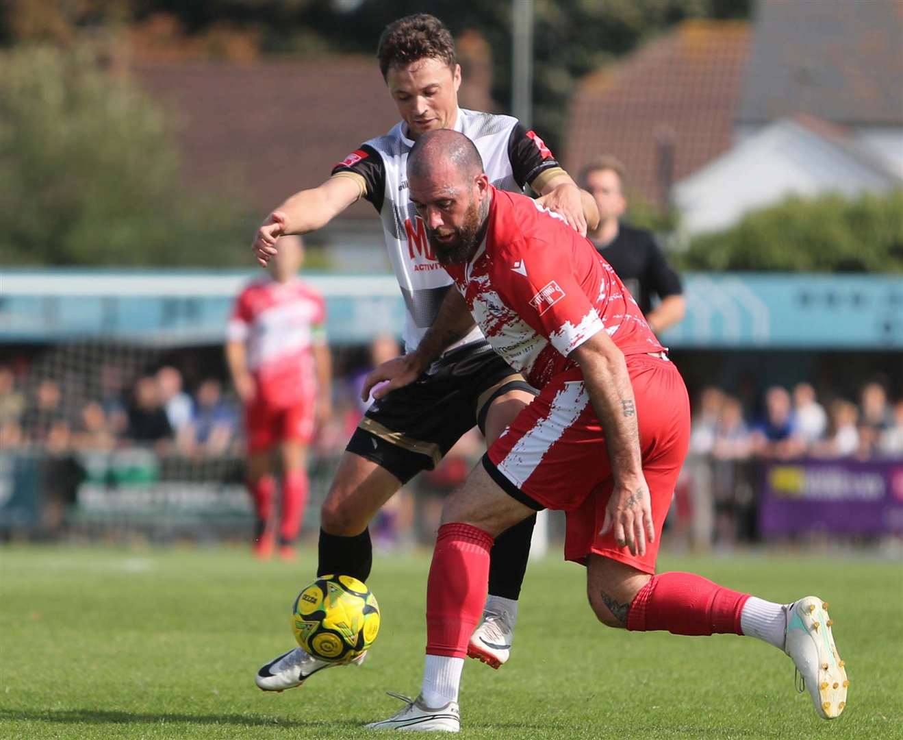 Deal's Rory Smith up against Ramsgate defender Joe Ellul as the Rams won the derby in front of a huge crowd 4-2 on Bank Holiday Monday. Picture: Paul Willmott