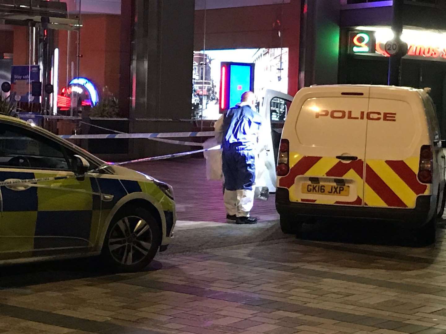 A forensics officer loads evidence bags into his van after a man was stabbed in Week Street, Maidstone