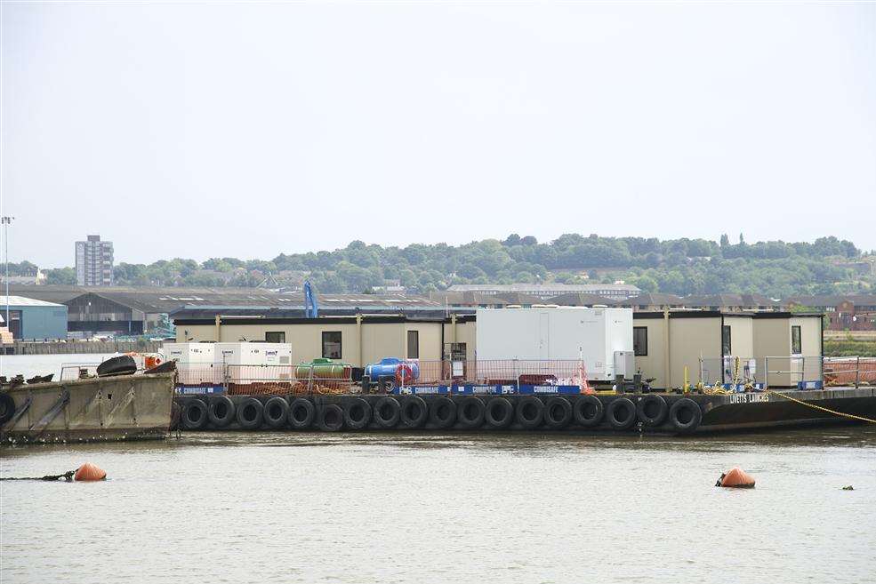 Cabins and equipment on a barge near the sub