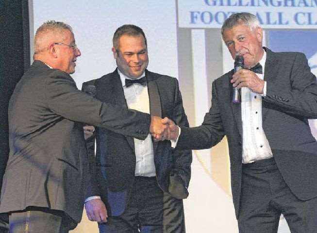 Gills chairman Paul Scally shakes on a four-year deal with MEMS boss Colin Jarvis, watched by MD Glen Jarvis