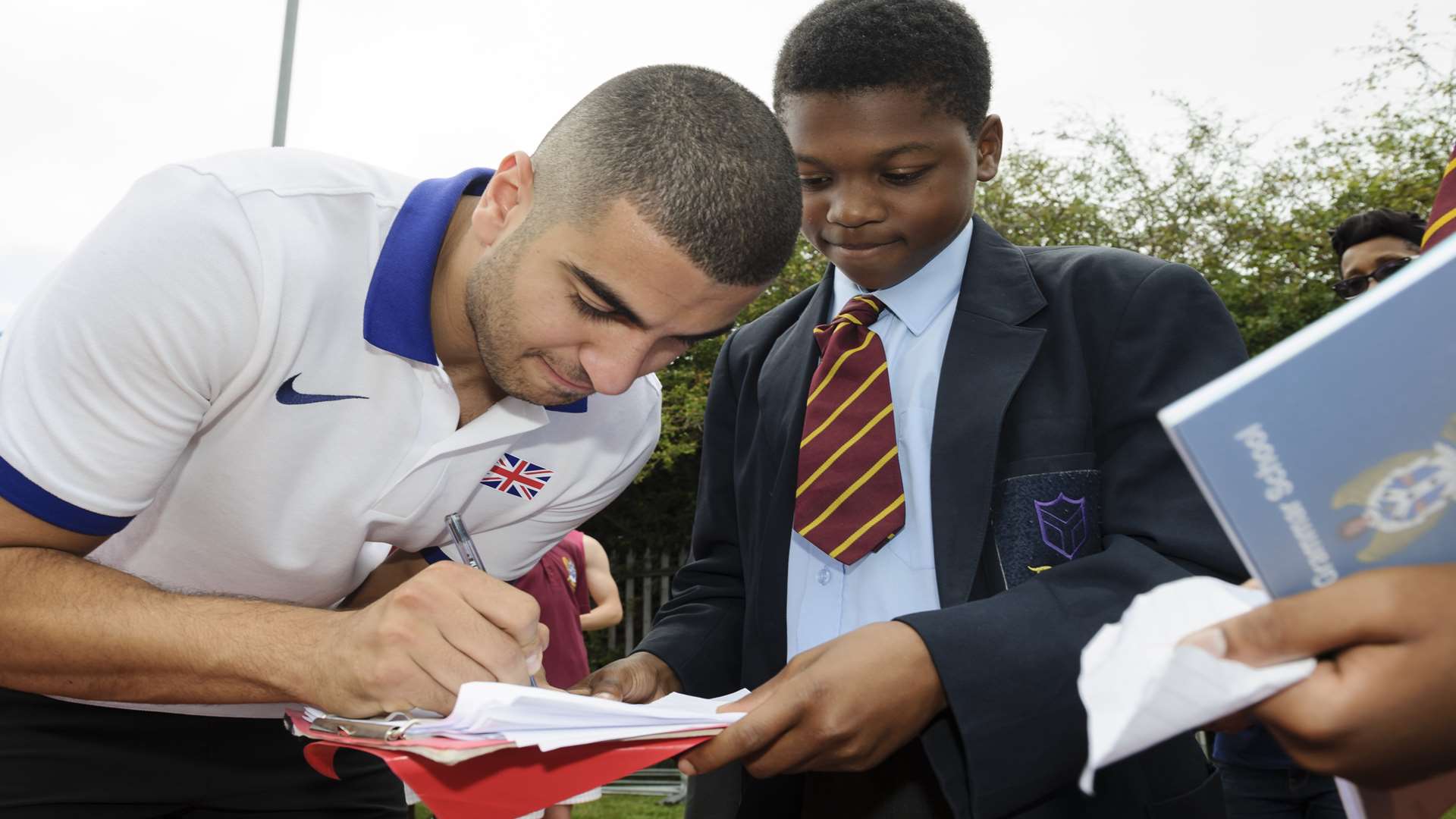 Bayo Fapetu, 12, gets an autograph from Adam