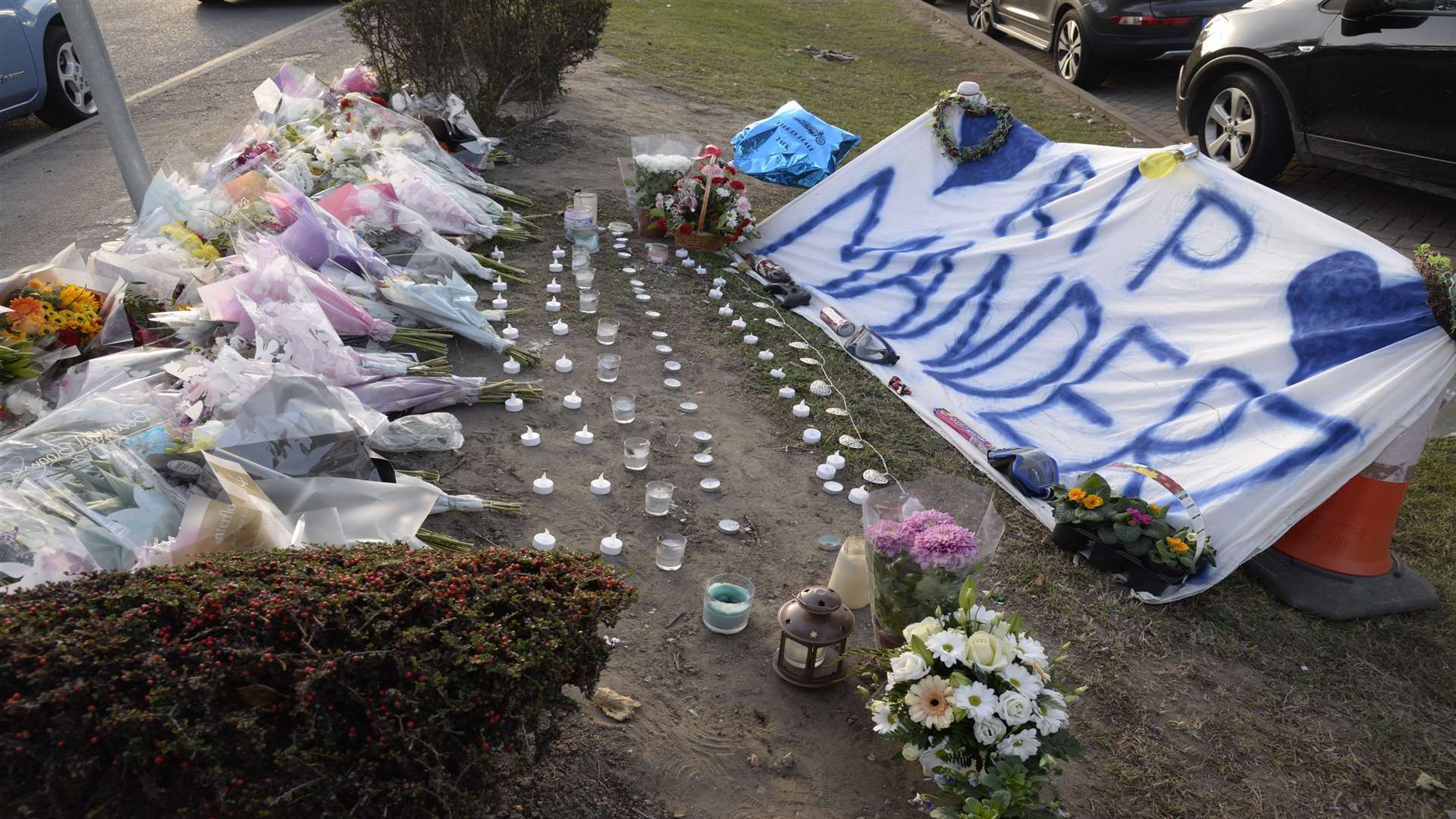 The floral tributes and candles left at the scene.