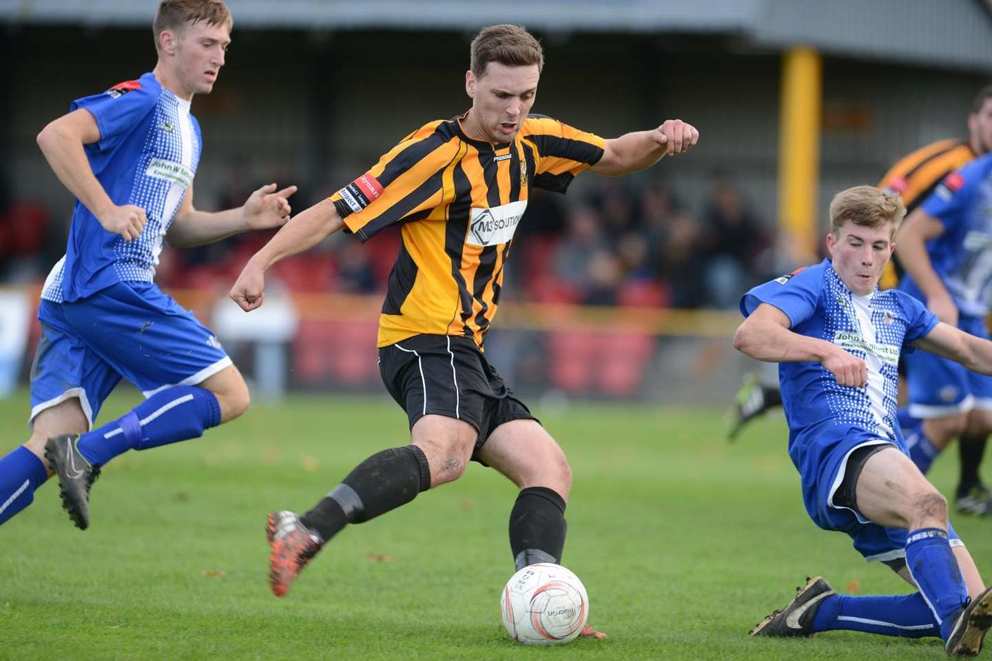 Joe Taylor drives forward for Folkestone against Herne Bay at the Fullicks Stadium