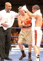 Referee Ian John-Lewis looks on as Armour congratulates Kaya on his victory. Picture: MATT WALKER