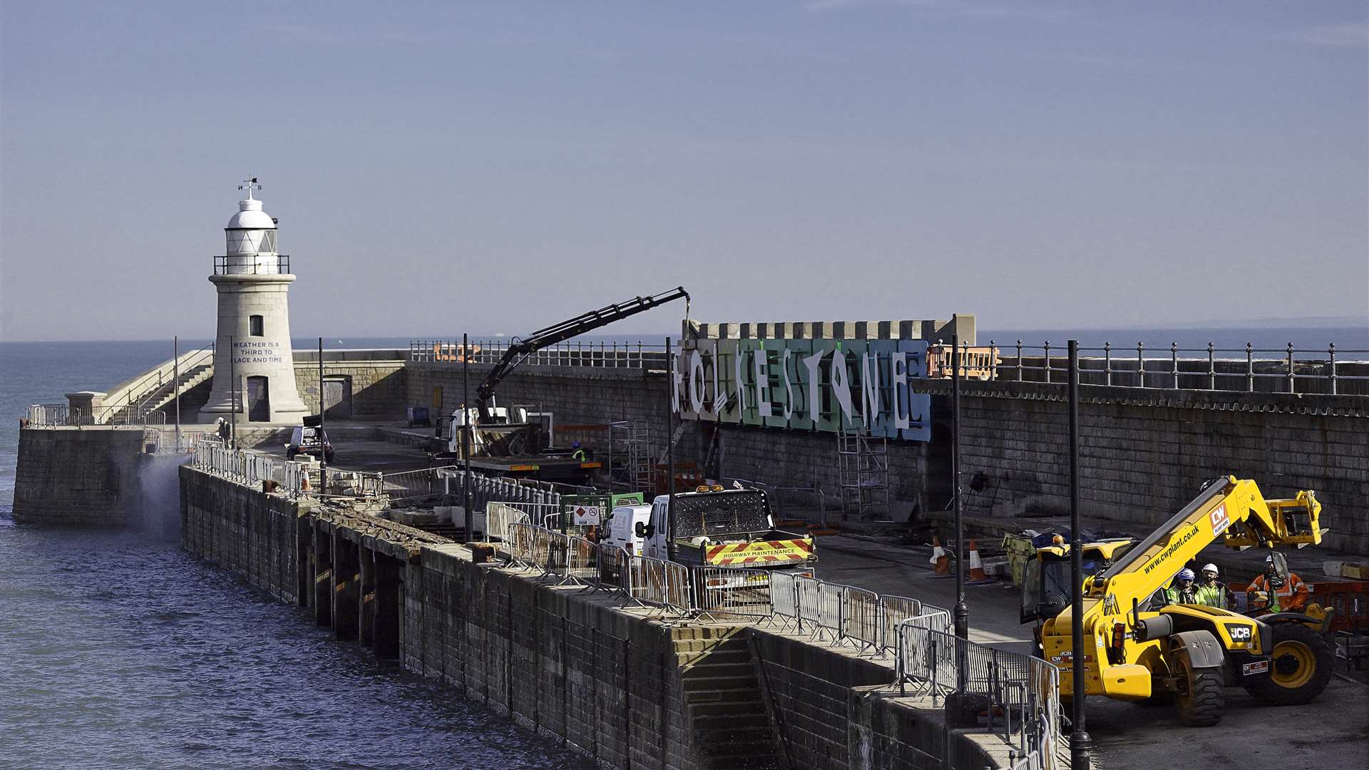 Workmen reinstall the Folkestone sign on the harbour arm after going through a refurbishment. Picture: Richard Taylor