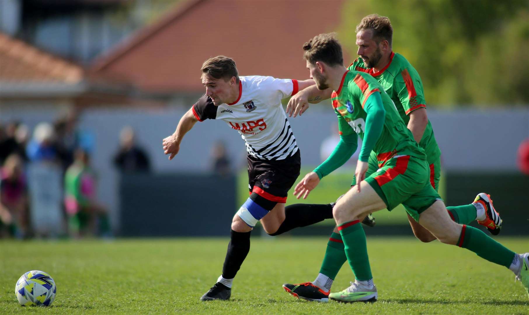 Deal's Tom Chapman tries to take on Lydd's Kane Penn as he starts to move away from another away player as the Hoops earn a 3-1 weekend win over the Lydders. Picture: Paul Willmott