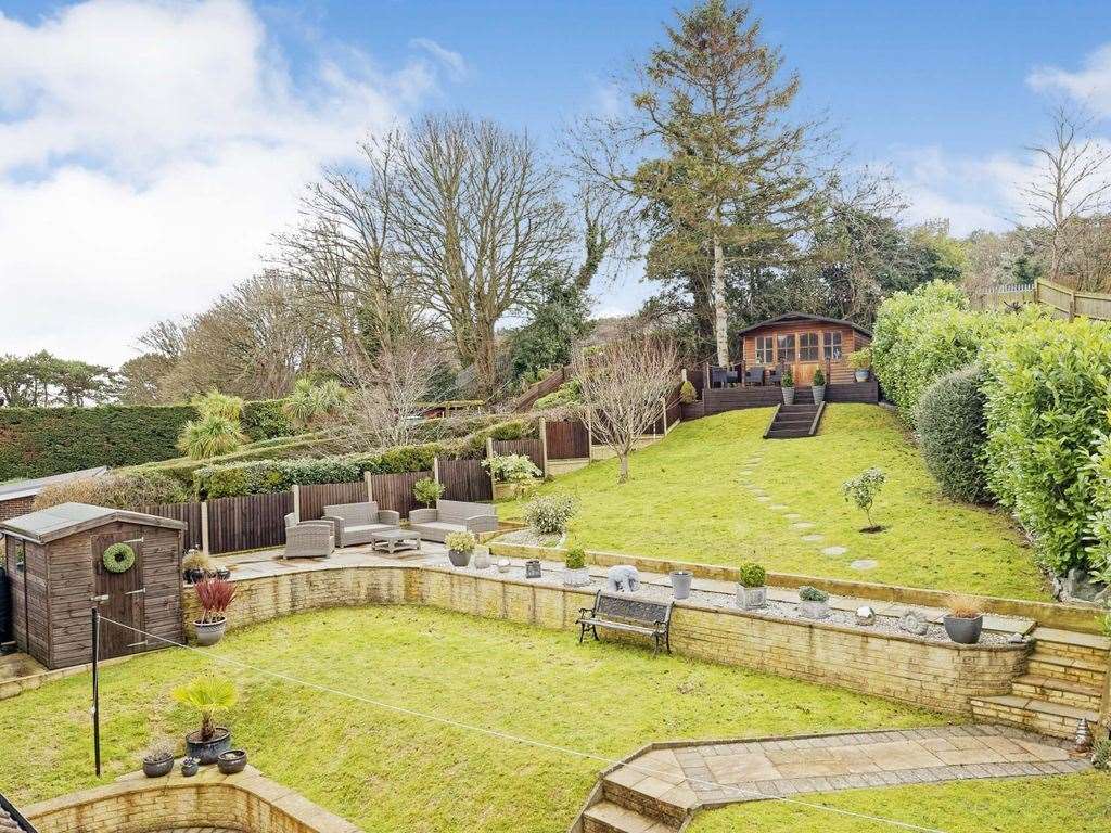 The rambling garden at the back of the Dover house features a tiled patio area. Photo: Zoopla