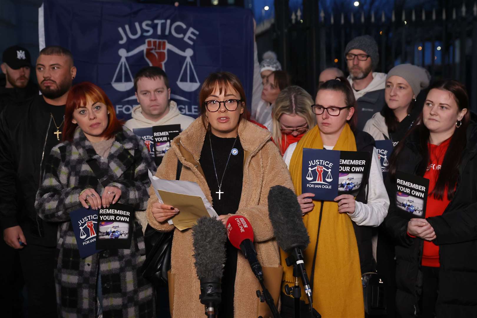 Toni Johnston (centre), daughter of Ian Ogle, speaking outside Laganside Courts, Belfast (Liam McBurney/PA)