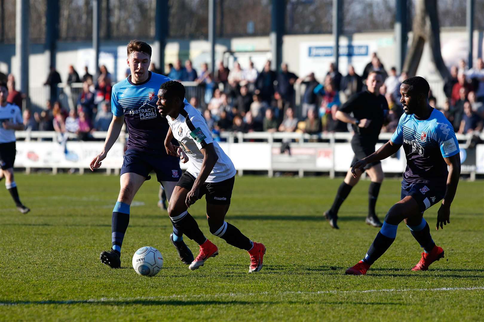 Darren McQueen looks to get in between Woking's defenders Picture: Andy Jones