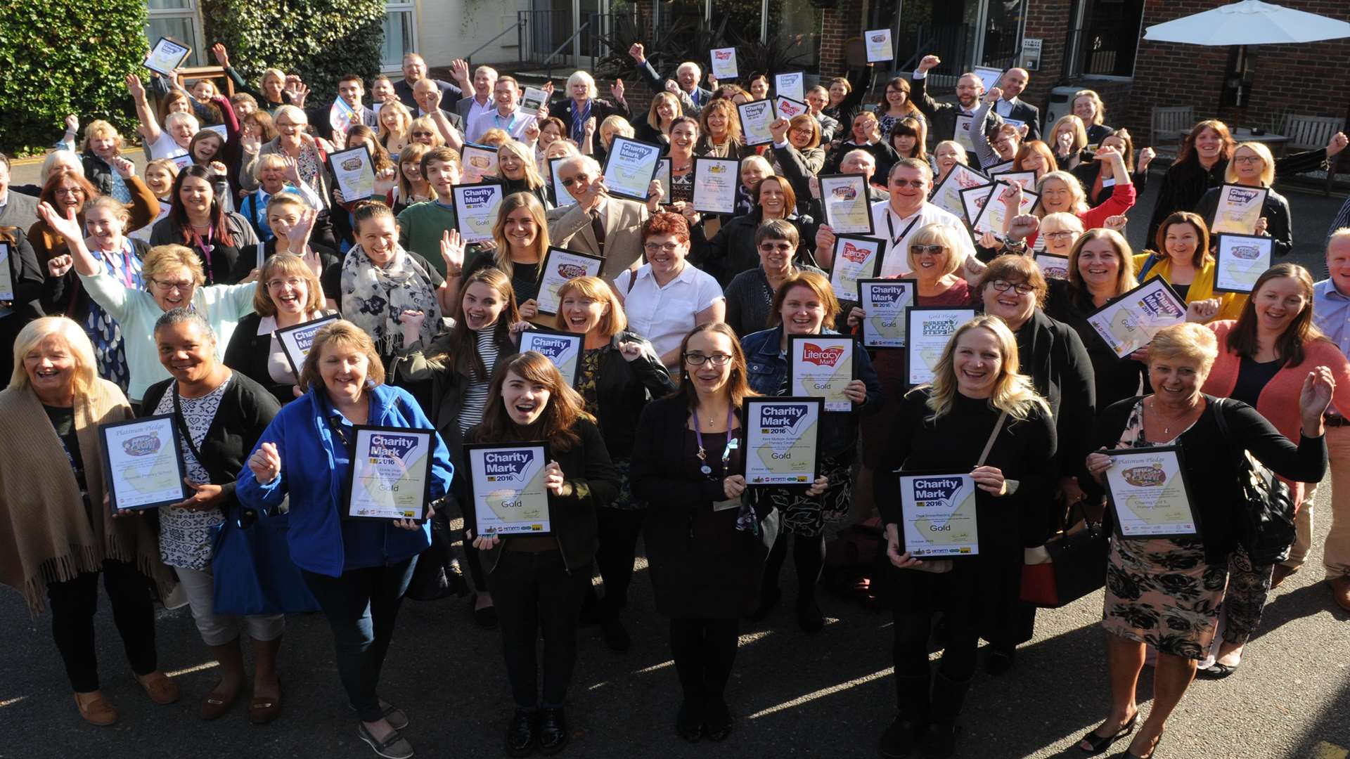 Delegates attending the KM Charity Forum celebrate receiving their awards.