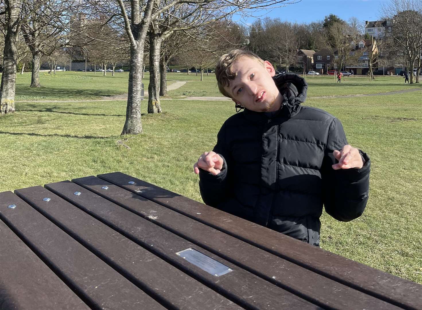 Helen's son Jack sitting at his late grandad's bench