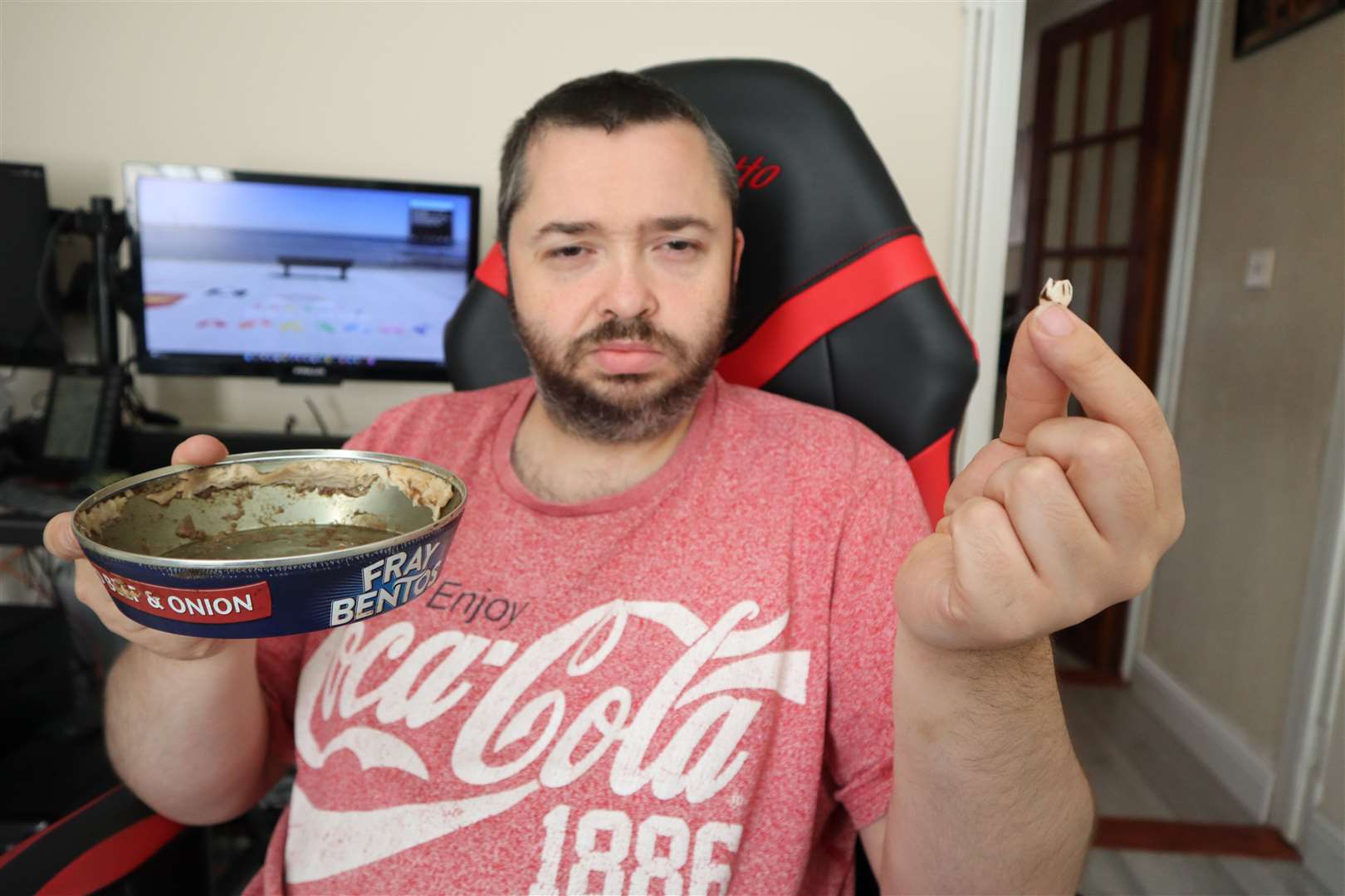 Adam Young and the tooth he says he found in a Fray Bentos minced beef and onion pie. Picture: John Nurden