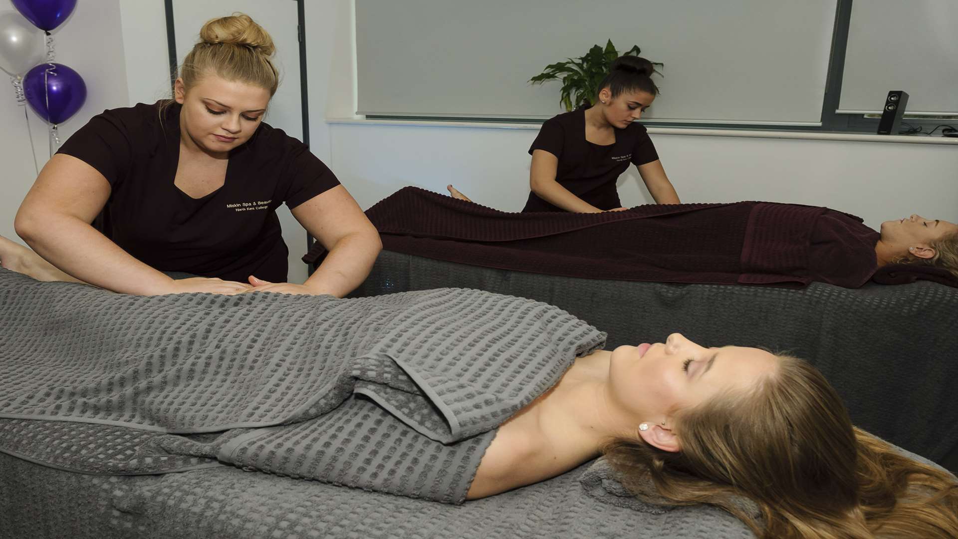 Lottie Birmington is massaged by Millie Thompson. Official opening of the Miskin Spa, salon and make-up studio.