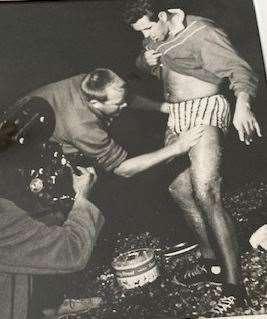 Michael being greased up on Dover beach before his second Channel swim in 1966