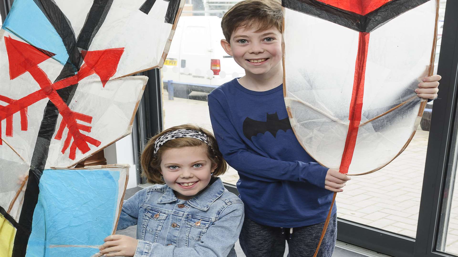 Lola Myers, seven, and her 10-year-old brother Dougie making giant feathers