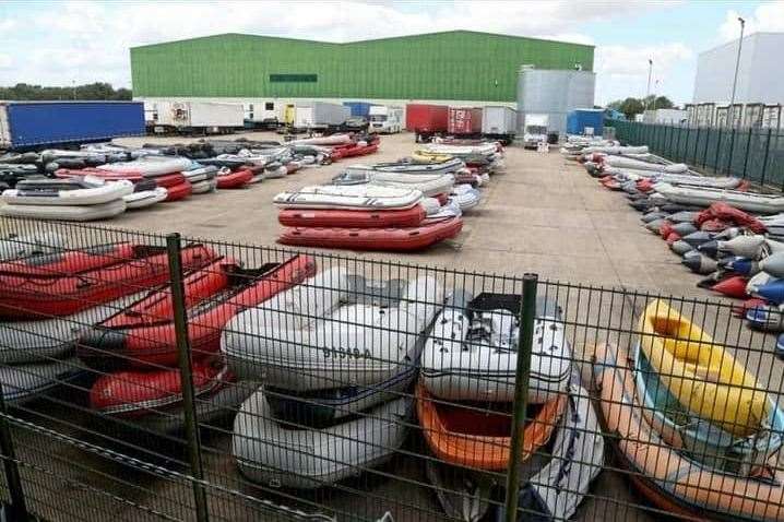 Abandoned dinghies used for Channel crossings piled three high in a compound. Picture: Chris Johnson