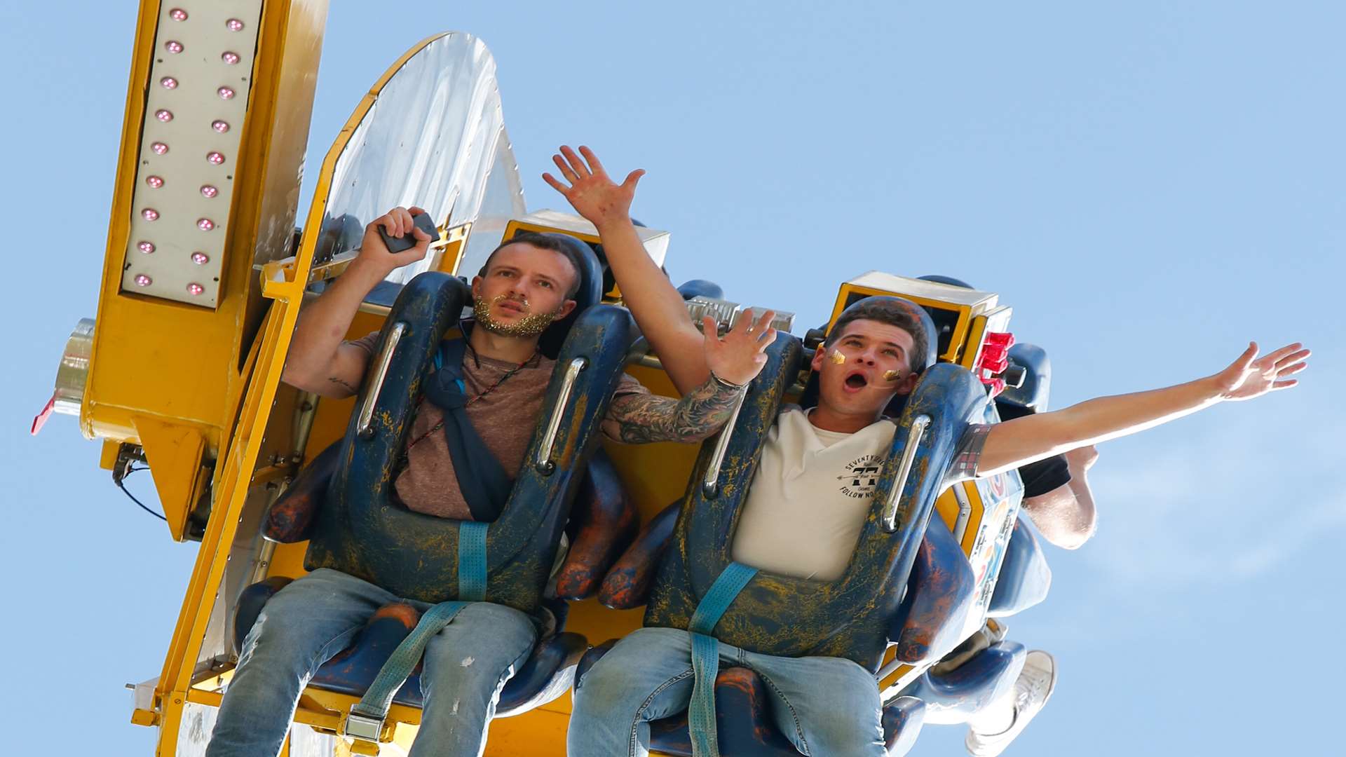 Festival goers enjoying the fairground rides