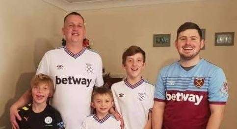 Reece, a West Ham fan, with his step-dad Steve and three younger brothers